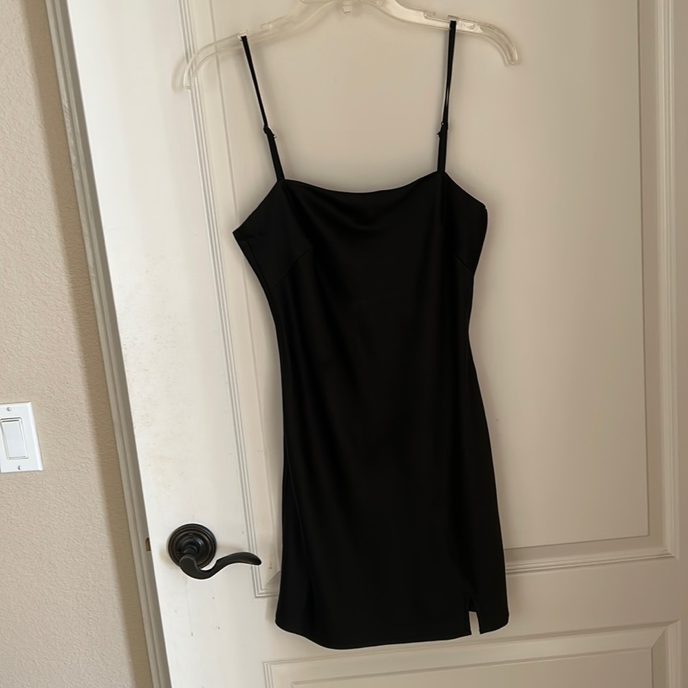 Black mini dress with small slit. Very cute and sexy